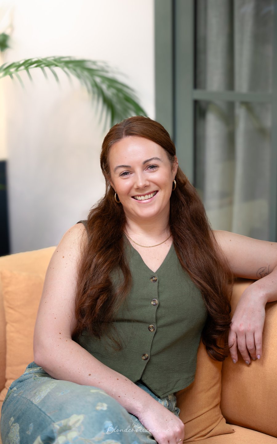Sophie, founder of Emerald Virtual, seated and smiling